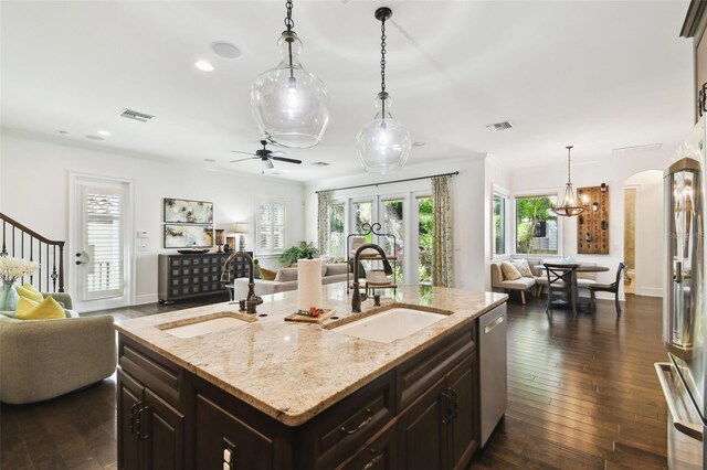 kitchen with visible vents, open floor plan, and a sink