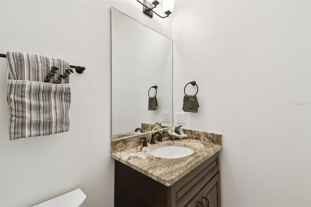 bathroom with toilet and vanity