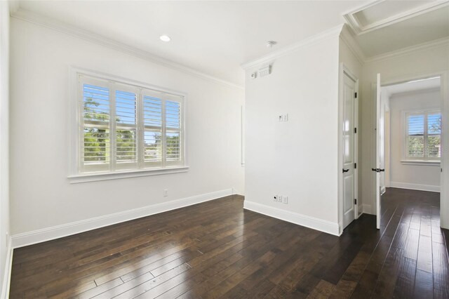 empty room with crown molding, baseboards, and dark wood-type flooring