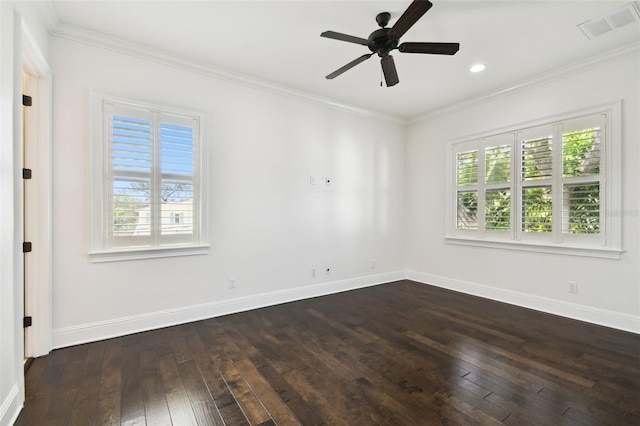 empty room with dark wood-style flooring, a healthy amount of sunlight, and visible vents