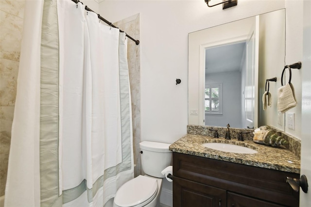 bathroom featuring toilet and vanity