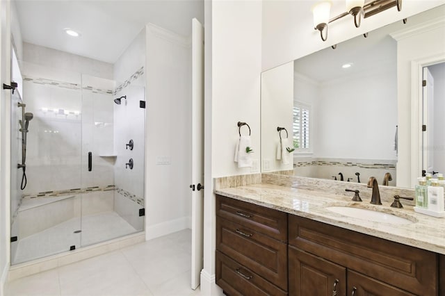 bathroom with a shower stall, vanity, tile patterned floors, baseboards, and ornamental molding