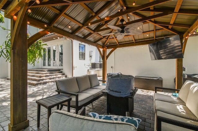 view of patio / terrace featuring outdoor lounge area, a gazebo, ceiling fan, and french doors