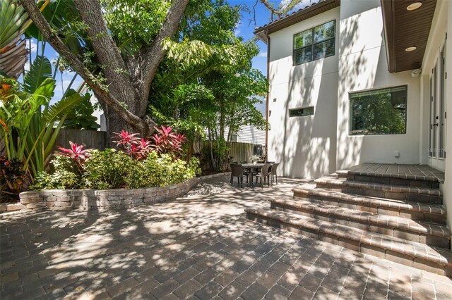 view of patio with outdoor dining space and fence