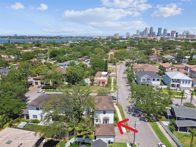 drone / aerial view featuring a residential view, a water view, and a city view