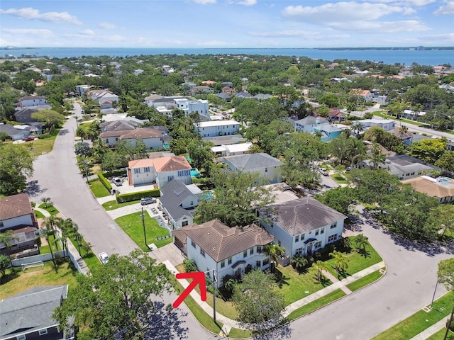 drone / aerial view with a water view and a residential view