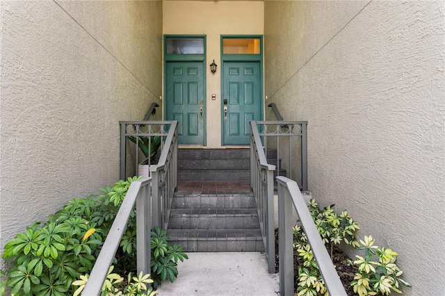 doorway to property featuring stucco siding