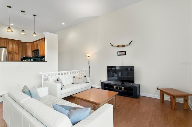 living room featuring recessed lighting, baseboards, and wood finished floors