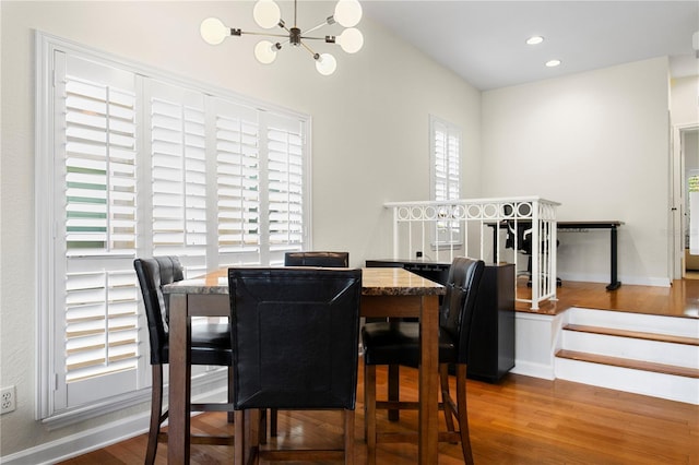 dining area with recessed lighting, a chandelier, and wood finished floors