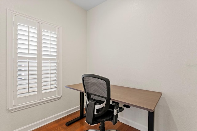 office featuring baseboards and wood finished floors