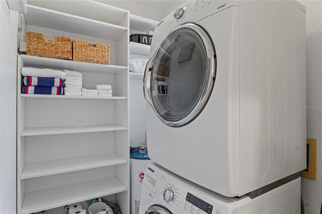 washroom featuring laundry area and stacked washer / dryer