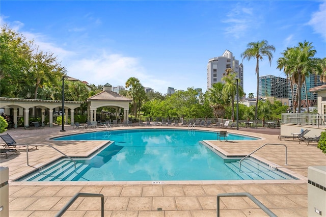 pool with a patio, a gazebo, and fence
