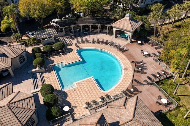 community pool featuring fence and a patio area