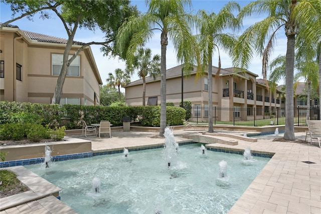 view of swimming pool with fence and a patio area