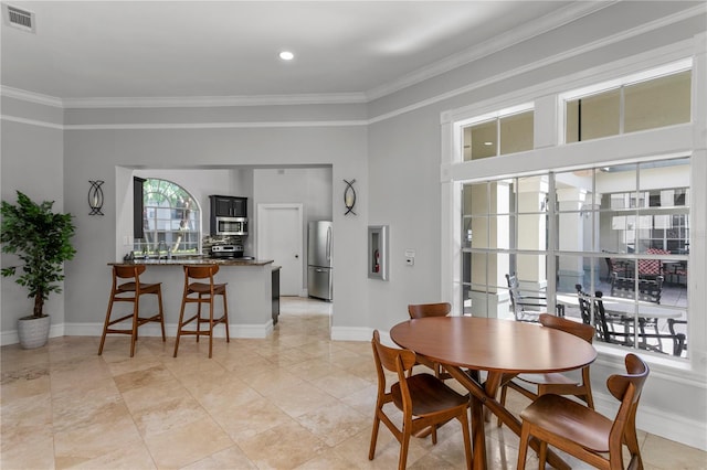 dining room featuring visible vents, recessed lighting, baseboards, and crown molding