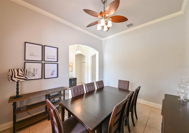 3254 Grassglen Pl, Wesley Chapel, FL 33544 - dining room featuring arched walkways, light tile patterned floors, a ceiling fan, and crown molding