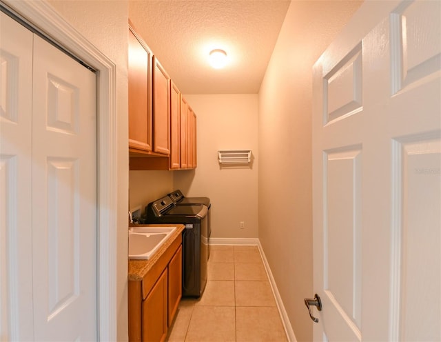 3254 Grassglen Pl, Wesley Chapel, FL 33544 - laundry area with washer and dryer, cabinet space, light tile patterned floors, and a textured ceiling