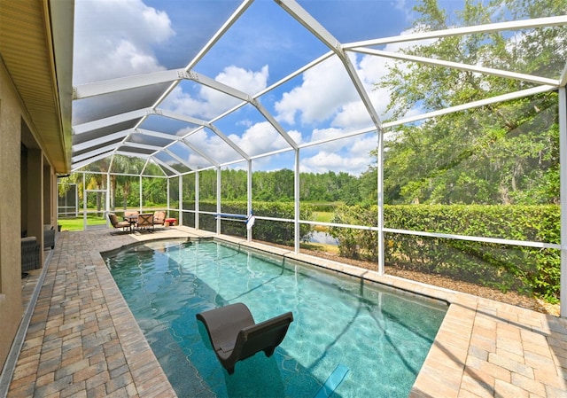 3254 Grassglen Pl, Wesley Chapel, FL 33544 - outdoor pool with a patio, a lanai, and view of wooded area