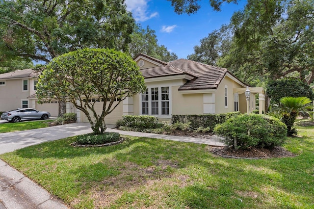 15314 Sherwood Forest Dr, Tampa, FL 33647 - view of front of property with a tiled roof, concrete driveway, a front yard, stucco siding, and an attached garage