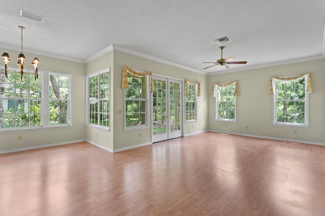 15314 Sherwood Forest Dr, Tampa, FL 33647 - unfurnished living room featuring a textured ceiling, light wood-style flooring, a ceiling fan, a chandelier, and ornamental molding