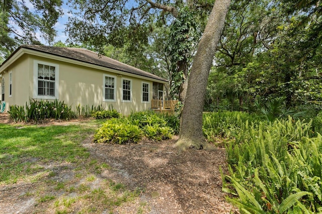 15314 Sherwood Forest Dr, Tampa, FL 33647 - view of home's exterior with a deck and stucco siding