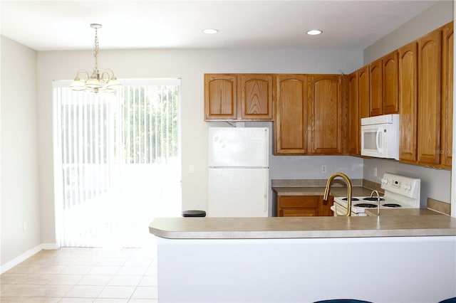 kitchen with an inviting chandelier, decorative light fixtures, a peninsula, white appliances, and brown cabinetry