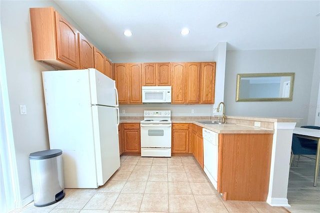 kitchen with recessed lighting, white appliances, light countertops, a sink, and a peninsula