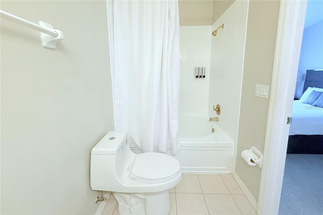 ensuite bathroom with tile patterned floors, shower / bath combo, toilet, and ensuite bathroom