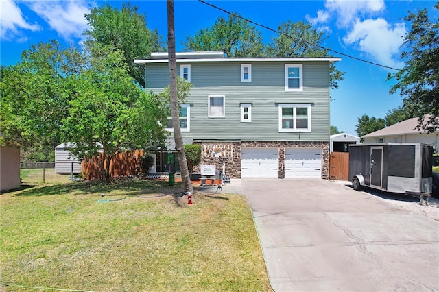view of front facade with fence, a garage, driveway, stone siding, and a front yard