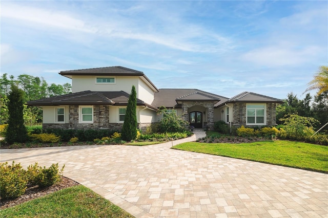 17305 Ballmont Park Dr, Odessa, FL 33556 - prairie-style home featuring stucco siding, french doors, a front lawn, and stone siding