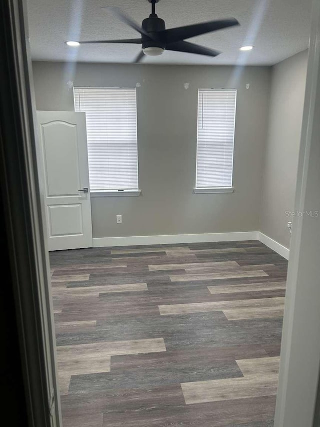 unfurnished room with recessed lighting, a ceiling fan, baseboards, a textured ceiling, and wood finished floors