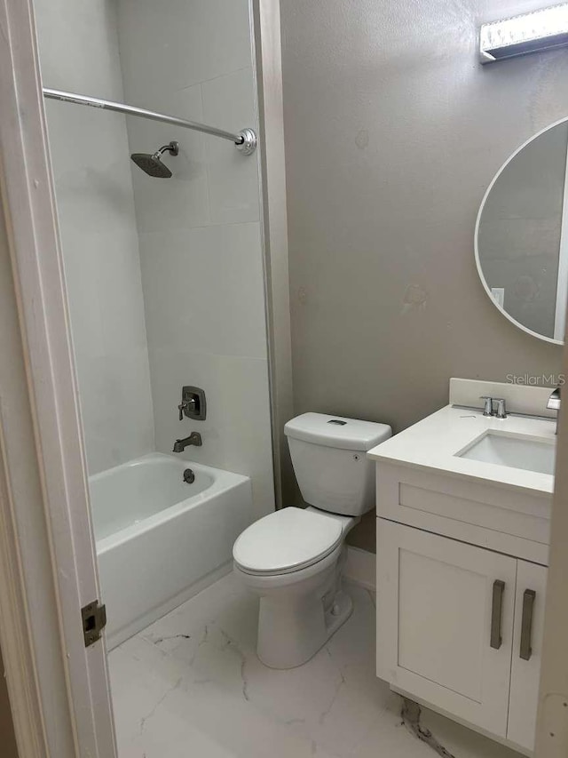 bathroom with bathtub / shower combination, toilet, vanity, and marble finish floor