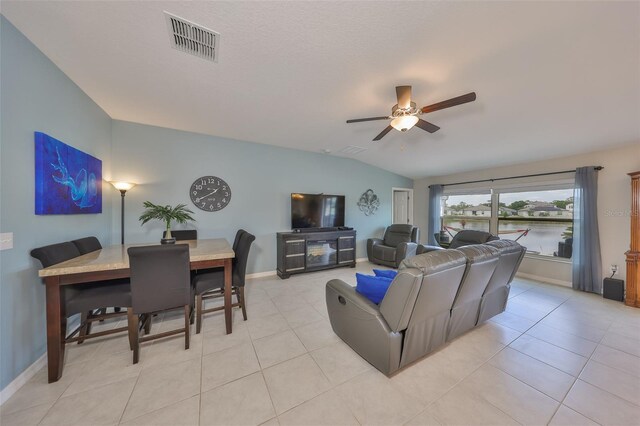 15426 Wicked Strong St, Sun City Center, FL 33573 - living area featuring vaulted ceiling, a ceiling fan, baseboards, and light tile patterned flooring