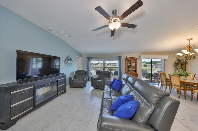 15426 Wicked Strong St, Sun City Center, FL 33573 - living room with light tile patterned floors, lofted ceiling, a chandelier, and a ceiling fan