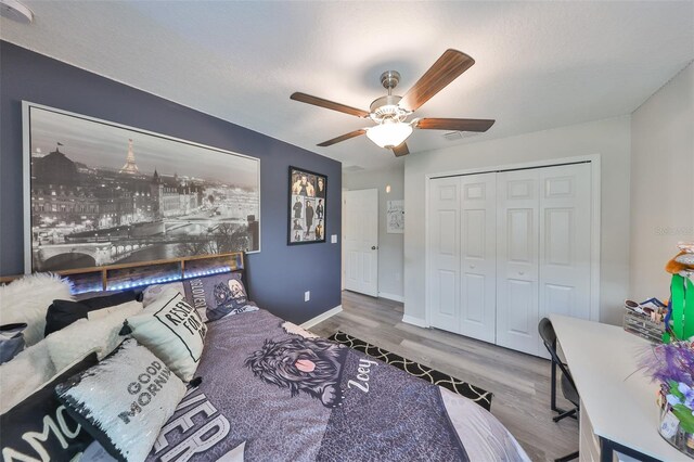 15426 Wicked Strong St, Sun City Center, FL 33573 - bedroom with wood finished floors, a closet, ceiling fan, and baseboards