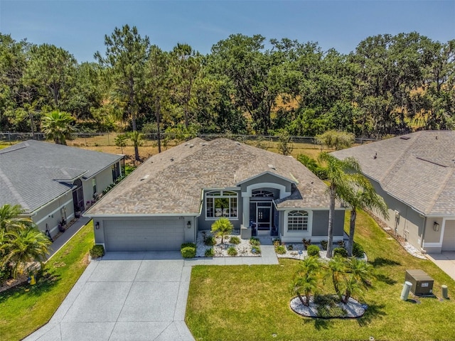 9723 Rolling Cir, San Antonio, FL 33576 - ranch-style home with a garage, stucco siding, concrete driveway, and a front yard