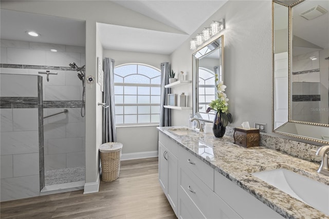 9723 Rolling Cir, San Antonio, FL 33576 - bathroom featuring baseboards, a sink, lofted ceiling, and a tile shower