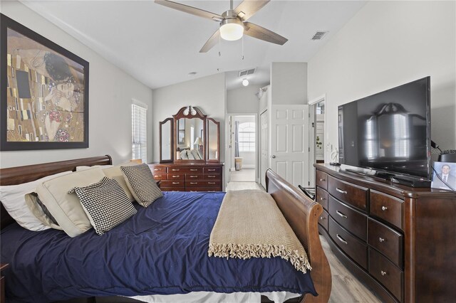 9723 Rolling Cir, San Antonio, FL 33576 - bedroom with light wood-style floors, lofted ceiling, connected bathroom, and visible vents