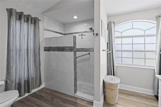 9723 Rolling Cir, San Antonio, FL 33576 - bathroom featuring toilet, a wealth of natural light, tiled shower, and wood finished floors