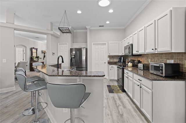 9723 Rolling Cir, San Antonio, FL 33576 - kitchen featuring stainless steel appliances, a breakfast bar, ornamental molding, and a toaster
