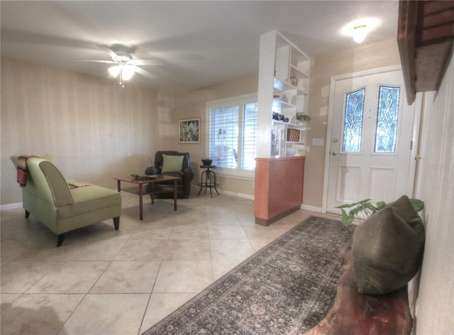 foyer entrance featuring light tile patterned floors, baseboards, and ceiling fan