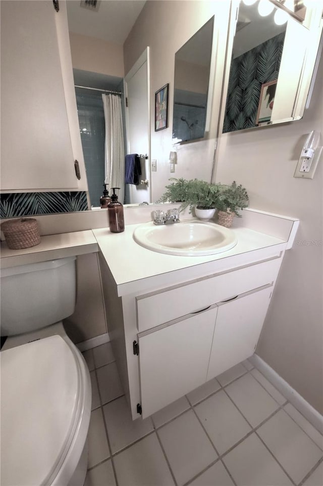 bathroom with toilet, visible vents, tile patterned flooring, and vanity