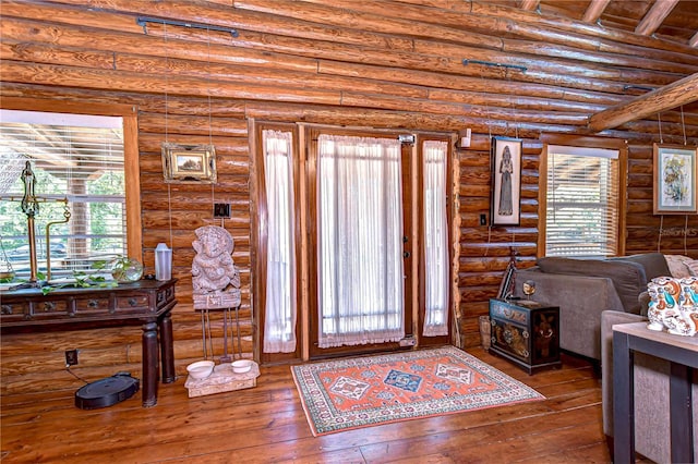 4126 Burrows Rd, Zephyrhills, FL 33542 - foyer entrance featuring log walls and hardwood / wood-style flooring