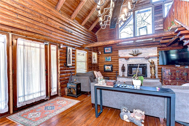 4126 Burrows Rd, Zephyrhills, FL 33542 - living room with hardwood / wood-style flooring, wooden ceiling, beam ceiling, a notable chandelier, and a stone fireplace