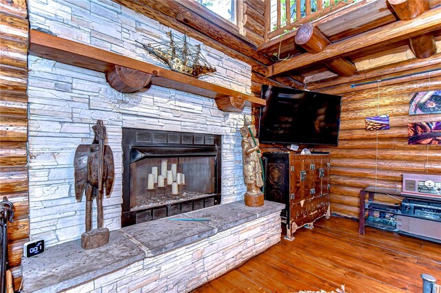 4126 Burrows Rd, Zephyrhills, FL 33542 - living room featuring hardwood / wood-style floors, rustic walls, and a fireplace