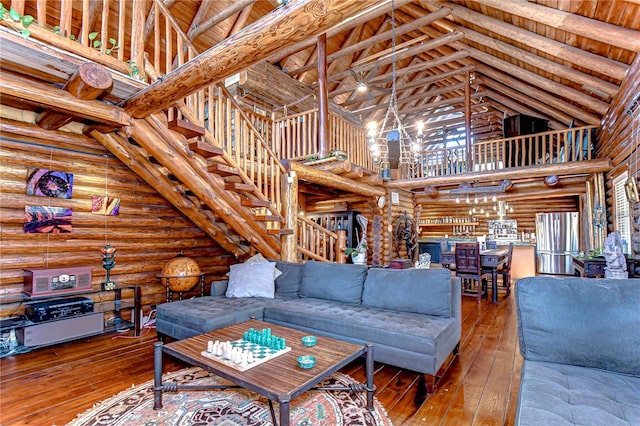 4126 Burrows Rd, Zephyrhills, FL 33542 - living room featuring log walls, high vaulted ceiling, and wood-type flooring