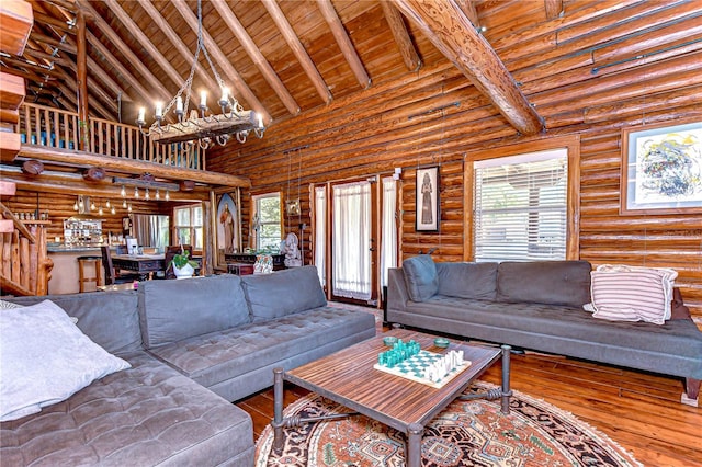 4126 Burrows Rd, Zephyrhills, FL 33542 - living room with rustic walls, wood finished floors, wood ceiling, high vaulted ceiling, and a notable chandelier