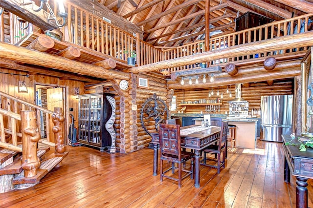 4126 Burrows Rd, Zephyrhills, FL 33542 - dining area with rustic walls, wooden ceiling, beam ceiling, high vaulted ceiling, and hardwood / wood-style floors