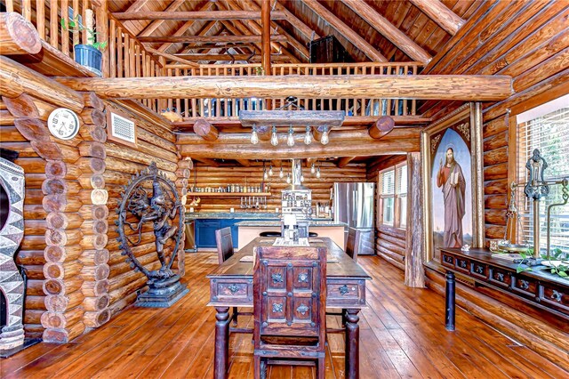 4126 Burrows Rd, Zephyrhills, FL 33542 - dining room featuring wood-type flooring, beam ceiling, visible vents, a high ceiling, and log walls