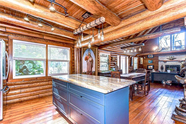 4126 Burrows Rd, Zephyrhills, FL 33542 - kitchen featuring beamed ceiling, light wood finished floors, pendant lighting, and wood ceiling
